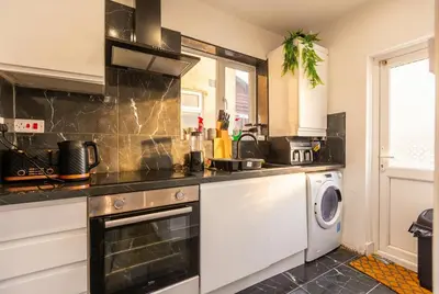 a kitchen with a stove and a dishwasher at Spacious 3-Bed Home for 8 | Free Parking & Garden in Havering atte Bower