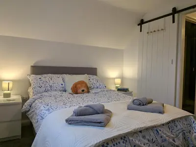 a dog laying on a bed with towels on it at Digby house flat 2 in West Mersea