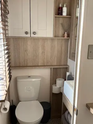 a small bathroom with a toilet and a sink at Bishops Beach Stays in Walton-on-the-Naze
