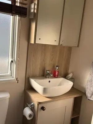 a bathroom with a sink and a toilet at Bishops Beach Stays in Walton-on-the-Naze
