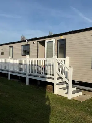 a mobile home with a porch and a deck at Bishops Beach Stays in Walton-on-the-Naze