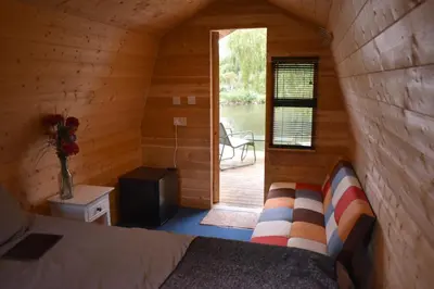 a room with a bed in a log cabin at Rum Bridge Glamping and Fishing Resort in Clare