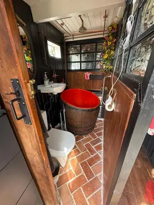 a bathroom with a tub and a toilet and a sink at Rum Bridge Glamping and Fishing Resort in Clare