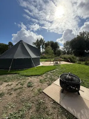 a large tent with a grill in a yard at Rum Bridge Glamping and Fishing Resort in Clare