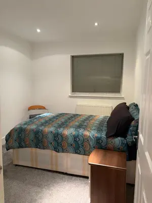 a bed in a room with a window and a bed sidx sidx sidx at The Croft Farmhouse Apartments in East Horndon