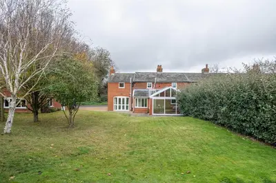 a large red brick house with a yard at 1 Box Iron Cottage, Shotley in Shotley