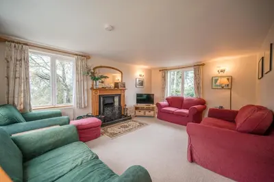 a living room with two couches and a fireplace at 1 Box Iron Cottage, Shotley in Shotley