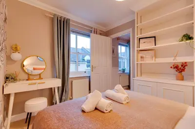 a bedroom with a bed with two towels at Stylish Modern Home in City Centre Free Parking - Pass the Keys in Cambridge