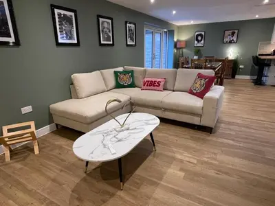 a living room with a couch and a coffee table at Luxury new build house nearr Science and Business parks in Cambridge
