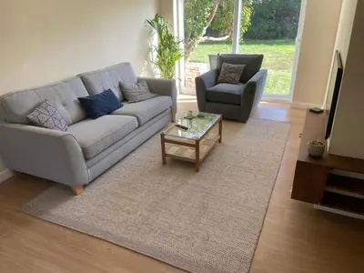 a living room with a couch and a coffee table at Comfortable Homestay by Earith Lakes in Earith