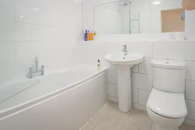 a white bathroom with a toilet and a sink at Central Victorian Villa 2 Floor I Parking I Garden in Cambridge