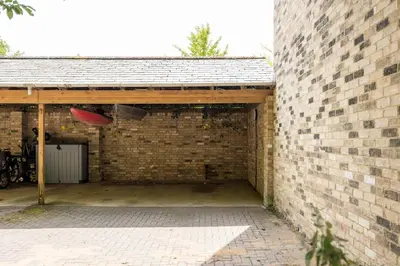 a brick garage with a red frisbee in the air at Central Victorian Villa 2 Floor I Parking I Garden in Cambridge