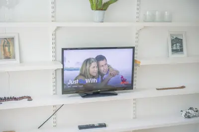 a television on a shelf in a living room at Central Victorian Villa 2 Floor I Parking I Garden in Cambridge