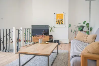 a living room with a coffee table and a tv at Central Victorian Villa 2 Floor I Parking I Garden in Cambridge