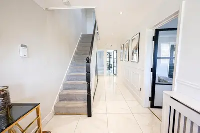 a hallway with stairs in a house at Luv home with pool and cinema room
