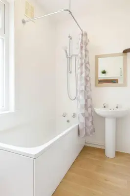 a white bathroom with a tub and a sink at 1 Bed Service Accommodation- contractor ready in Southend-on-Sea