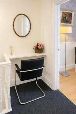 a black chair in a room with a mirror at 1 Bed Service Accommodation- contractor ready in Southend-on-Sea