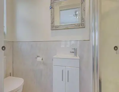a bathroom with a toilet and a sink and a mirror at Stunning home in Leigh Sleeps 5 - Pass the Keys in Southend-on-Sea
