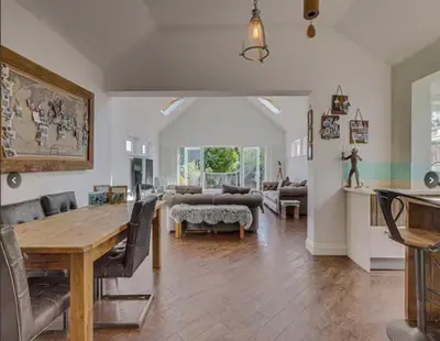 a large living room with a table and a couch at Stunning home in Leigh Sleeps 5 - Pass the Keys in Southend-on-Sea