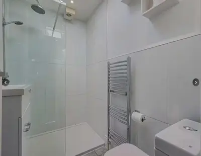 a white bathroom with a shower and a toilet at Stunning home in Leigh Sleeps 5 - Pass the Keys in Southend-on-Sea