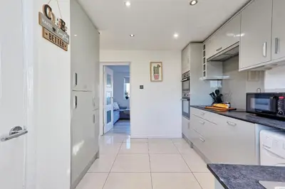 a kitchen with white cabinets and a counter top at Modern 4BR Sleeps 10, Free Parking, Basildon town, Contractor friendly in Basildon