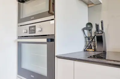 a kitchen with white cabinets and an oven at Modern 4BR Sleeps 10, Free Parking, Basildon town, Contractor friendly in Basildon