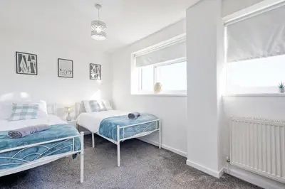 a bedroom with two beds and a window at Modern 4BR Sleeps 10, Free Parking, Basildon town, Contractor friendly in Basildon