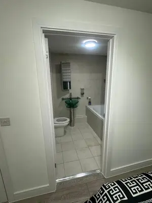 a bathroom with a tub and a toilet and a sink at Systematic Home in Battlesbridge