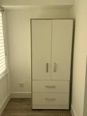 a white cabinet in a room with a mirror at Systematic Home in Battlesbridge