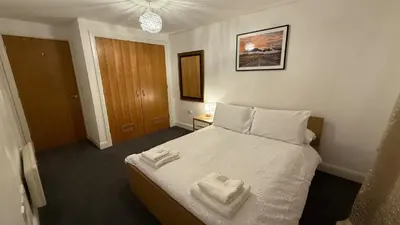 a bedroom with a bed with two towels on it at Guildford Court Apartment in Colchester in Colchester