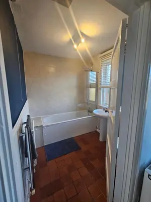 a bathroom with a tub and a toilet and a sink at Station House in Roudham