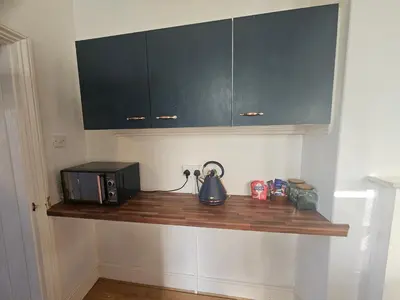 a kitchen with a counter with a toaster and a microwave at Station House in Roudham