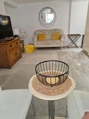 a living room with a table and a couch at Cosy Central 1-Bed with Parking & Wi-Fi in Ipswich