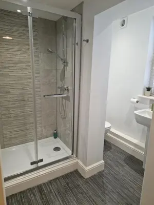 a shower with a glass door in a bathroom at Cosy Central 1-Bed with Parking & Wi-Fi in Ipswich