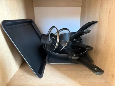 a black container filled with cooking utensils in a drawer at Coastal Beachfront Caravan in Brightlingsea