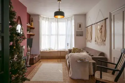 a living room with a christmas tree and a couch at 9 Chantry Road, Saxmundham in Saxmundham
