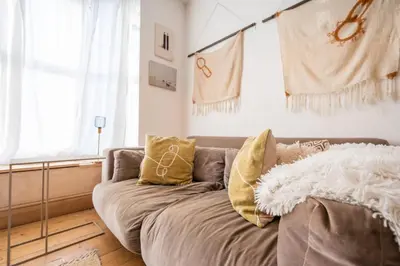 a living room with a couch with pillows on it at 9 Chantry Road, Saxmundham in Saxmundham