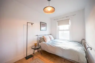 a bedroom with a bed and a window at 9 Chantry Road, Saxmundham in Saxmundham