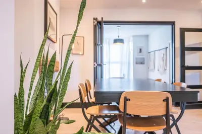 a dining room with a black table and chairs at 9 Chantry Road, Saxmundham in Saxmundham