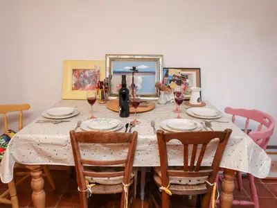 a dining room table with glasses of wine on it at The Hare & The Bumblebee Cottage in Eye