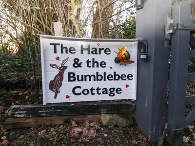 a sign for the haire and the bumblebee cottage at The Hare & The Bumblebee Cottage in Eye