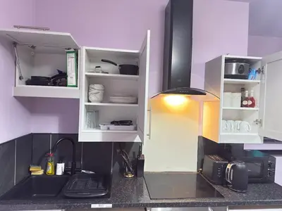 a kitchen with white cabinets and a kitchen sink at The Lavender Stay by Cambridge City Centre in Chesterton