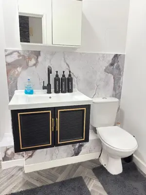 a bathroom with a sink and a toilet at The Charcoal Stay by Cambridge City Centre in Chesterton