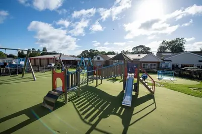 a park with a playground with a slide at Suntrail House in Great Clacton