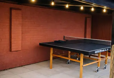 a ping pong table in front of a brick wall at Spacious 2BR Designer Home in Newmarket , Private Grounds & Garden in Newmarket