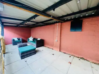 a room with two chairs and a red wall at Louisville Flat 3 in Newmarket