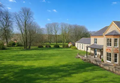 a house with a large yard with green grass at Louisville Flat 3 in Newmarket