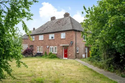 an old brick house with a red door at Keralia in Wivenhoe