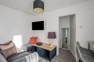 a living room with a couch and a table at Keralia in Wivenhoe