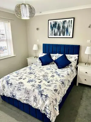 a blue bed with blue pillows in a bedroom at Charming 1-Bedroom Flat - Chelmsford City Centre in Chelmsford